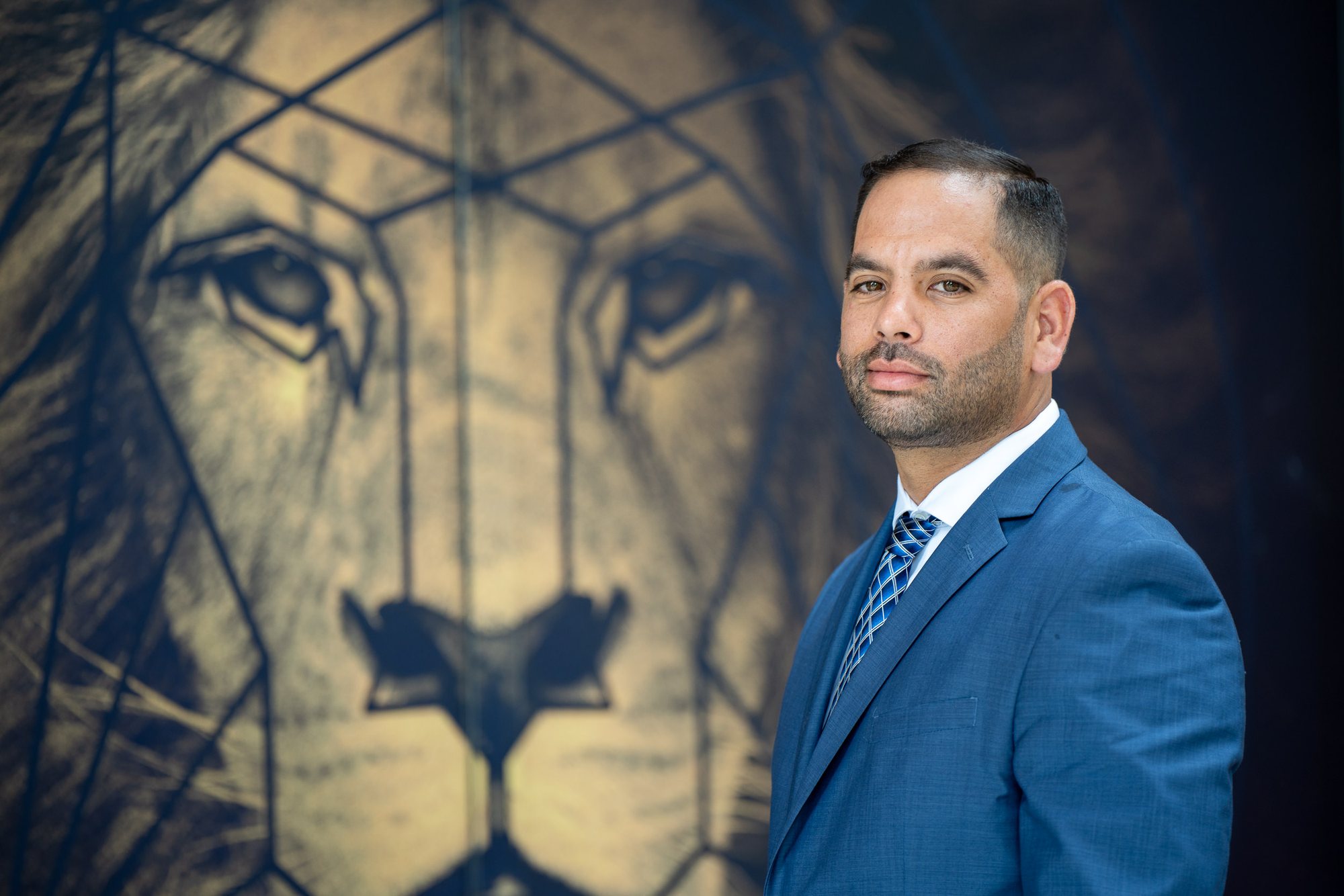 Erik J. Lichter, Miami attorney and founder of The Lichter Law Group, before the firm's lion mural